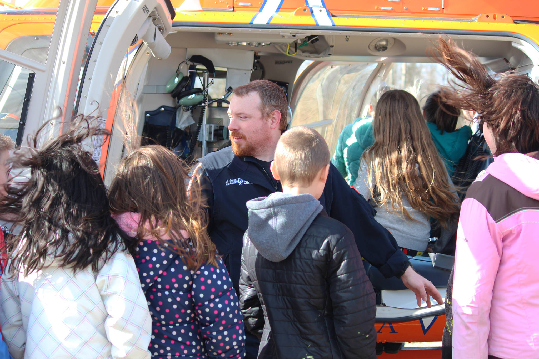 Paramedic Wes Raley shows the inside of a LifeMed helicopter to students from Chapman School on Friday, May 11, 2018 at the school in Anchor Point, Alaska (Photo by Megan Pacer/Homer News)
