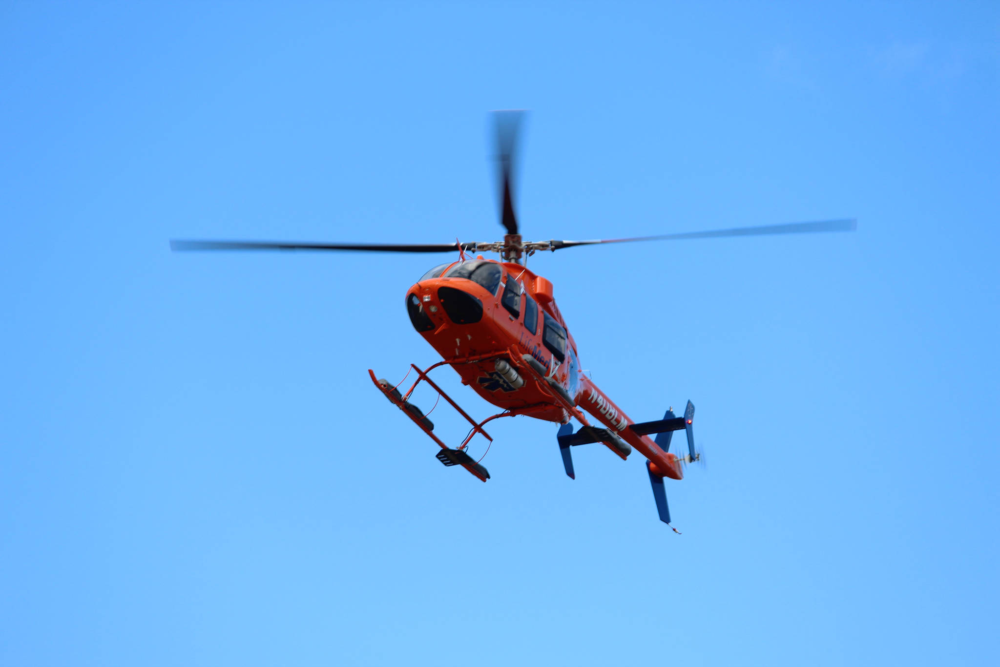 A LifeMed helicopter based out of Soldotna prepares to land in the field behind Chapman School on Friday, May 11, 2018 in Anchor Point, Alaska as part of a demonstration for students. (Photo by Megan Pacer/Homer News)