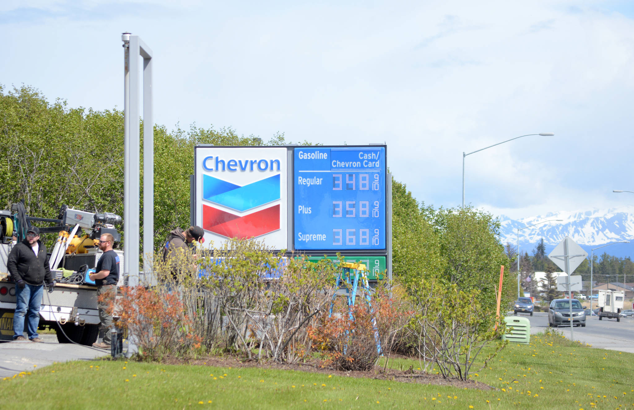 Workers with Prism Design and Construction, Wasilla, on Thursday, May 31, install Chevron signs at the Essential One gas station on the Sterling Highway and Poopdeck Street. (Photo by Michael Armstrong/Homer News)
