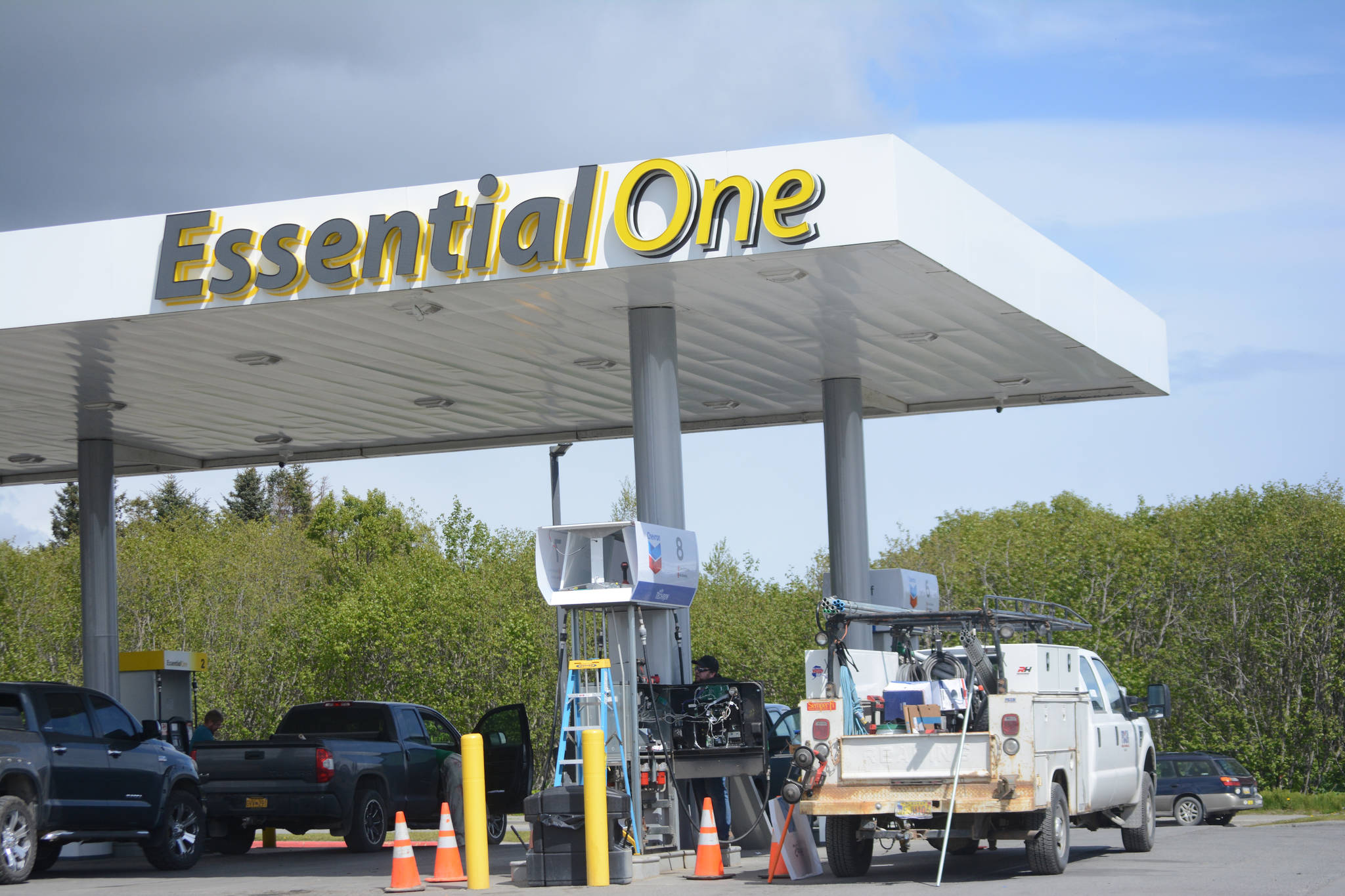 A worker with Prism Design and Construction, Wasilla, on Thursday, May 31, installs Chevron signs at the Essential One gas station on the Sterling Highway and Poopdeck Street. (Photo by Michael Armstrong/Homer News)