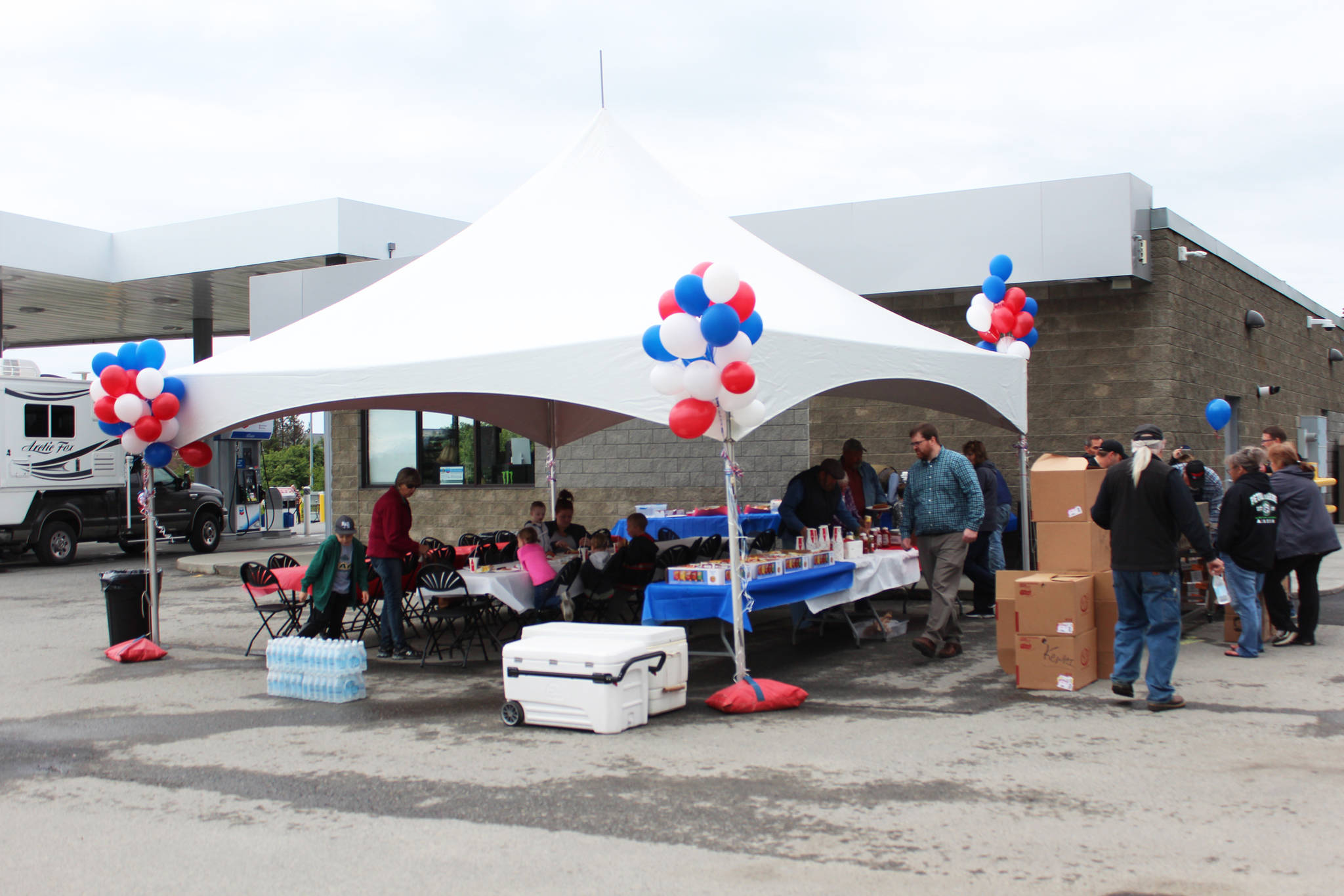 <span class="neFMT neFMT_PhotoCredit">Photo by Megan Pacer/Homer News</span>                                Community members enjoy free food during the grand opening of the Chevron gas station Saturday, June 23, 2018 on Homer Bypass Road in Homer, Alaska. In converting the Essential One station to Chevron, four new pumps were added to the property.