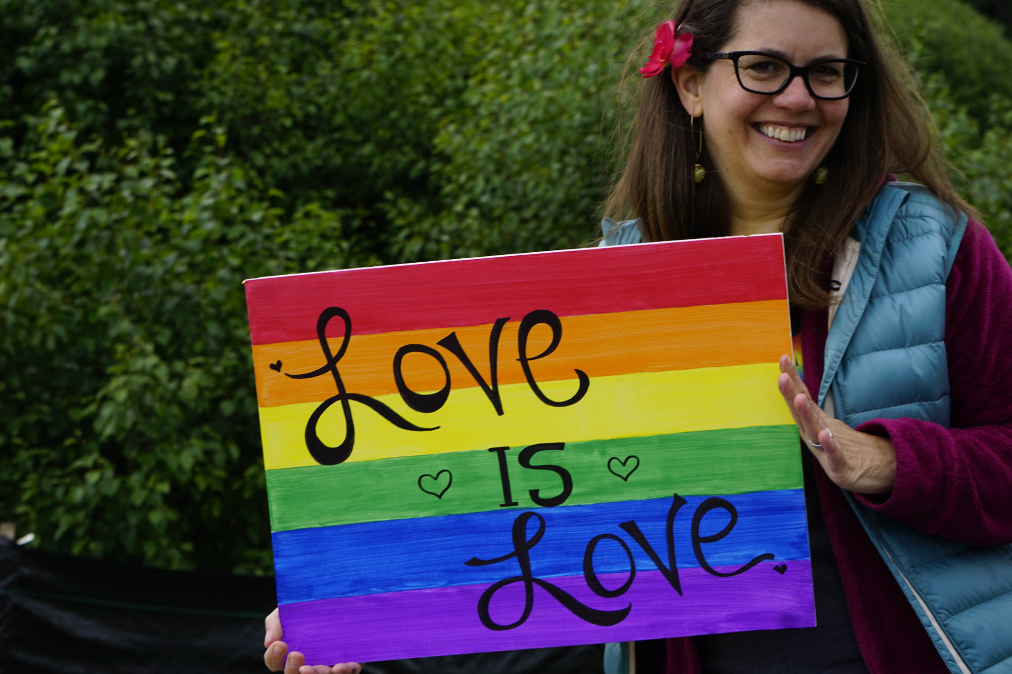 Kevyn Jalone shows a sign she carried in the Pride March on Saturday, June 23, 2018 in Homer, Alaska. (Photo by Michael Armstrong/Homer News)