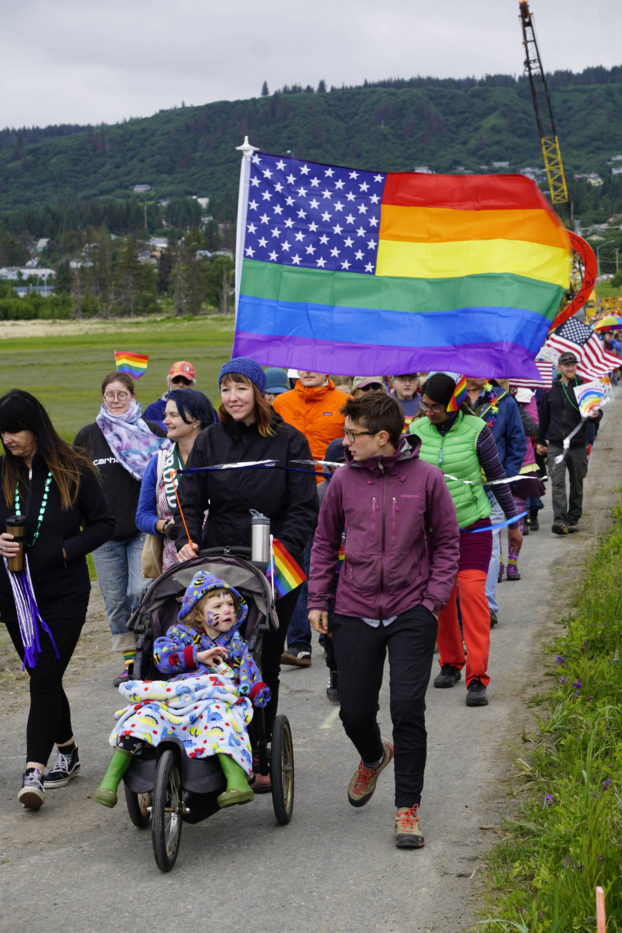 Participants in the Pride March walk over Beluga Slough on Saturday, June 23, 2018 in Homer, Alaska. (Photo by Michael Armstrong/Homer News)