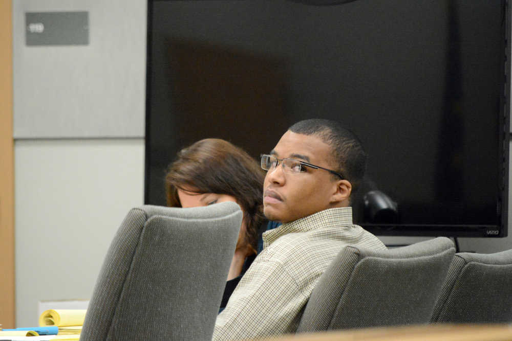 Demarqus Green listens to testimony at his trial on Friday. Green is charged with the murder of Demian Sagerser.