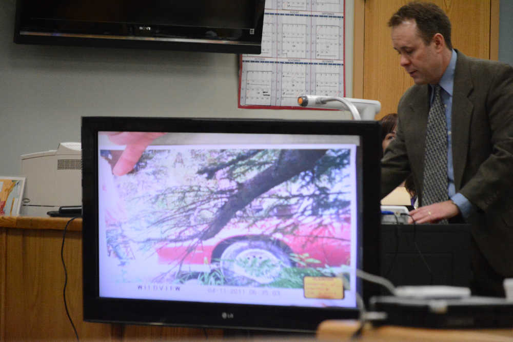 Kenai District Attorney Scot Leaders points to the image of a person in a red jacket during the trial of Demarqus Green on Friday. Green is charged with the murder of Demian Sagerser. The photo was taken by a game camera outside Sagerser's Stariski home.