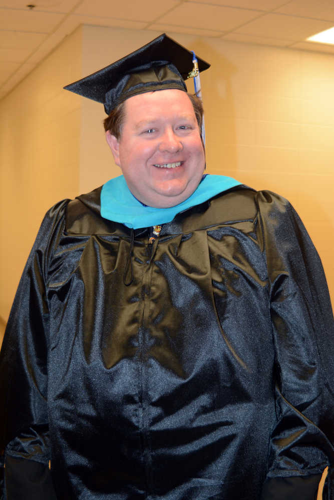 Terry Rensel poses for a photo after receiving a master of public administration at Kachemak Bay Campus commencement last Wednesday.
