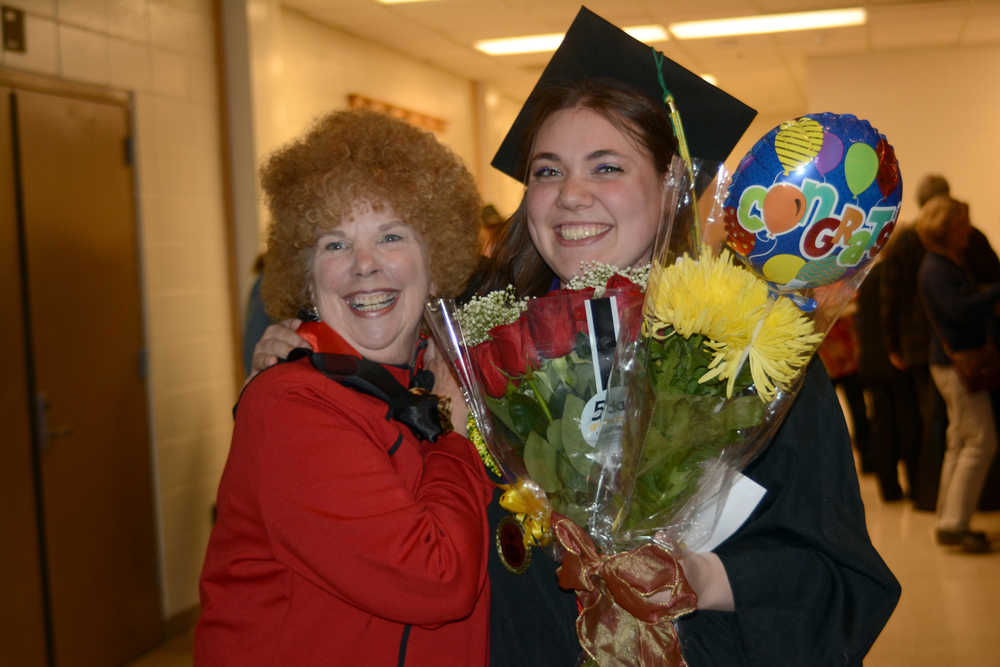 Cora Trowbridge, right, poses with Shawnie Olson, left, after she graduated with an associate of applied science degre in early childhood development University of Alaska Regent Lisa Parker confers the master of education hood for early childhood after Kachemak Bay Campus commencement last Wednesday.