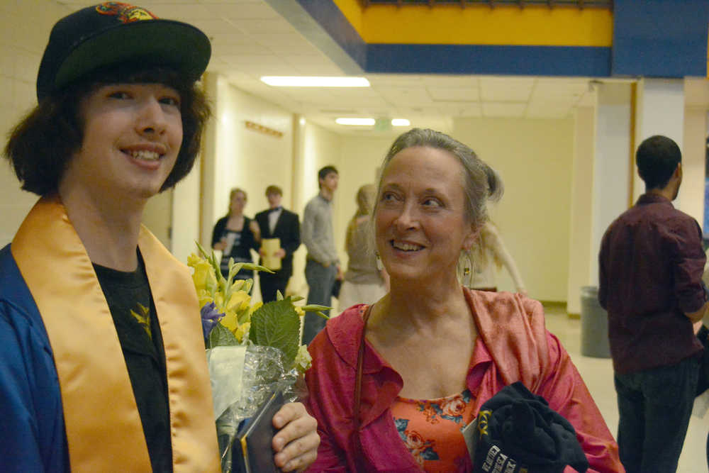 Elias Gibson, left, poses for a photo with his mother, Debi Poore, right.