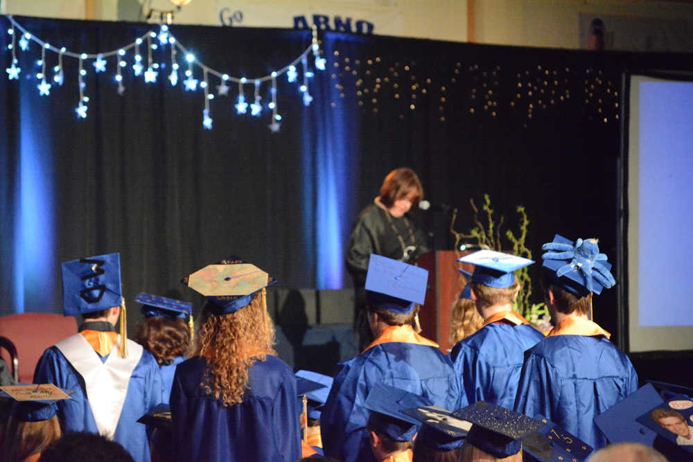 Homer High School graduates stand as counselor Lin Hampson reads their names and the scholarships they received. Graduates earned $890,305 in scholarships.