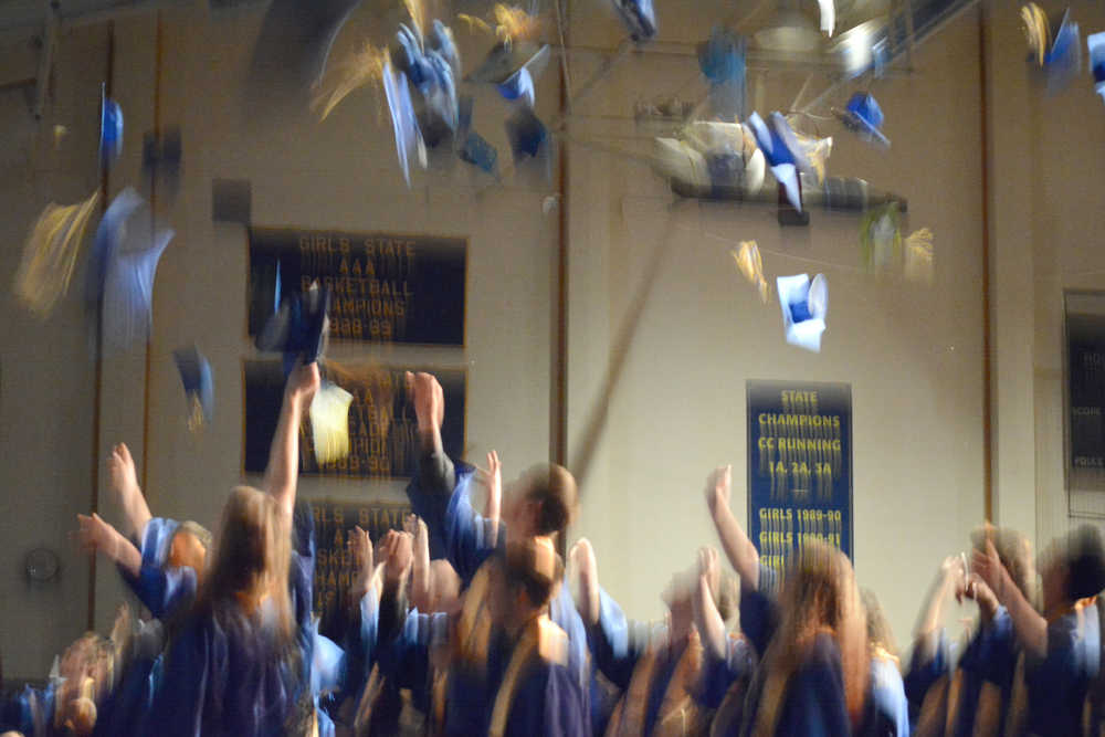 Homer High School graduates throw their caps in the air at the end of commencement exercises on Tuesday.