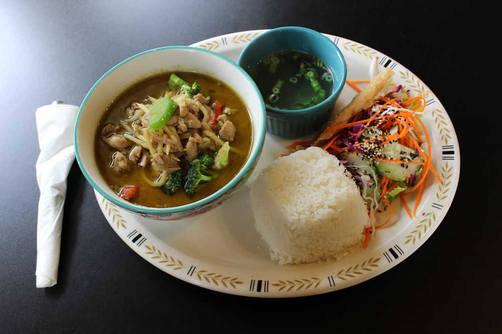 CUTLINE: Keen Kow Thai Food's green curry, served with rice, soup and salad, is an excellent opportunity for diners to put both their fork and spoon to work and discover the myriad flavors that emerge by mixing a bite of this and a bite of that.