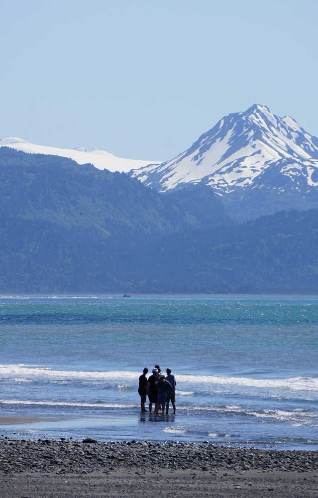 Wading weather  Warm temperatures on Tuesday prompted this group of young people to dip their toes in Kachemak Bay to cool off.