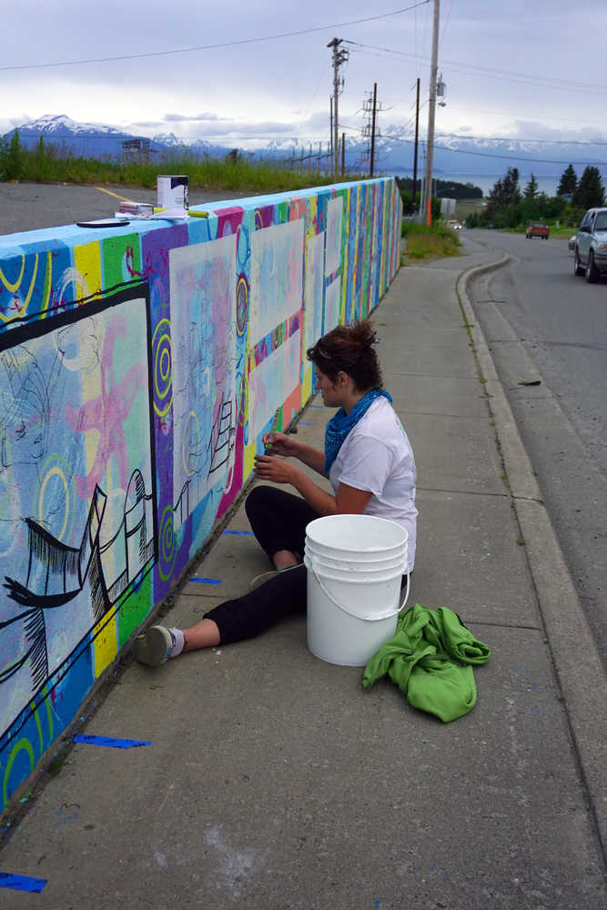 Kady Perry works on the Heath Street mural last Friday.