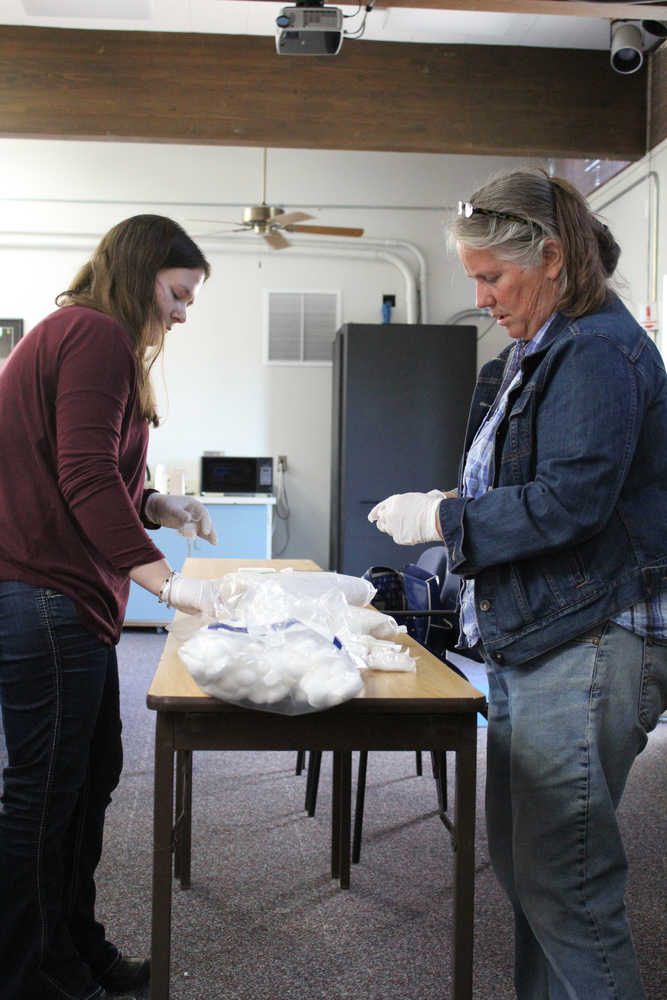 Organizers of The Exchange Megan Anderson and Ginny Espenshade fill bags with sterile cotton pellets for the safer injection kits. Intraveneous drug users without access to sterile cotton pellets use cigarette filters or cotton swabs to filter the drug as it is drawn into the syringe, said organizer Megan Anderson.