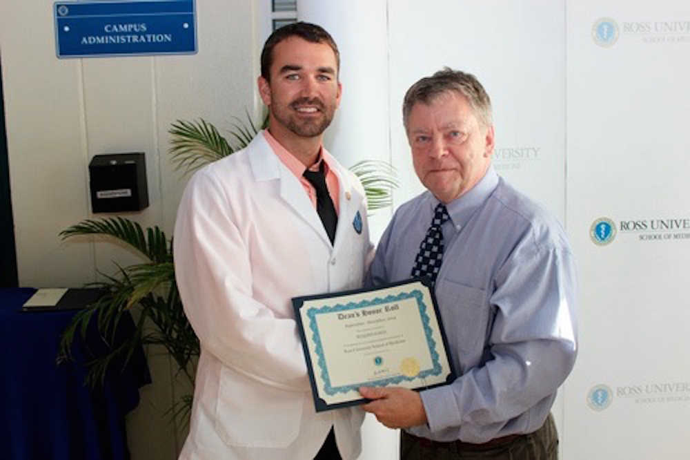 Homer native and Ross University School of Medicine student Ben Kuhns poses with senior associate dean of the Dominica campus after receiving his certificate for the dean's honor roll. Kuhns placed on the dean's list all four semesters during his first two years at medical school. Senior Associate Dean, Dominica Campus