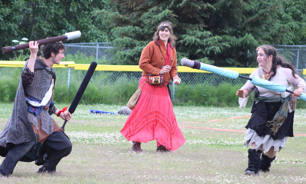 Rowyn Cunningham and Sage Thomas prepare to battle each other as Samantha Cunningham looks on. The Shire of IceFire Bay meets on Saturday afternoons from 4-7 p.m. at Karen Hornaday Park to play battle games.