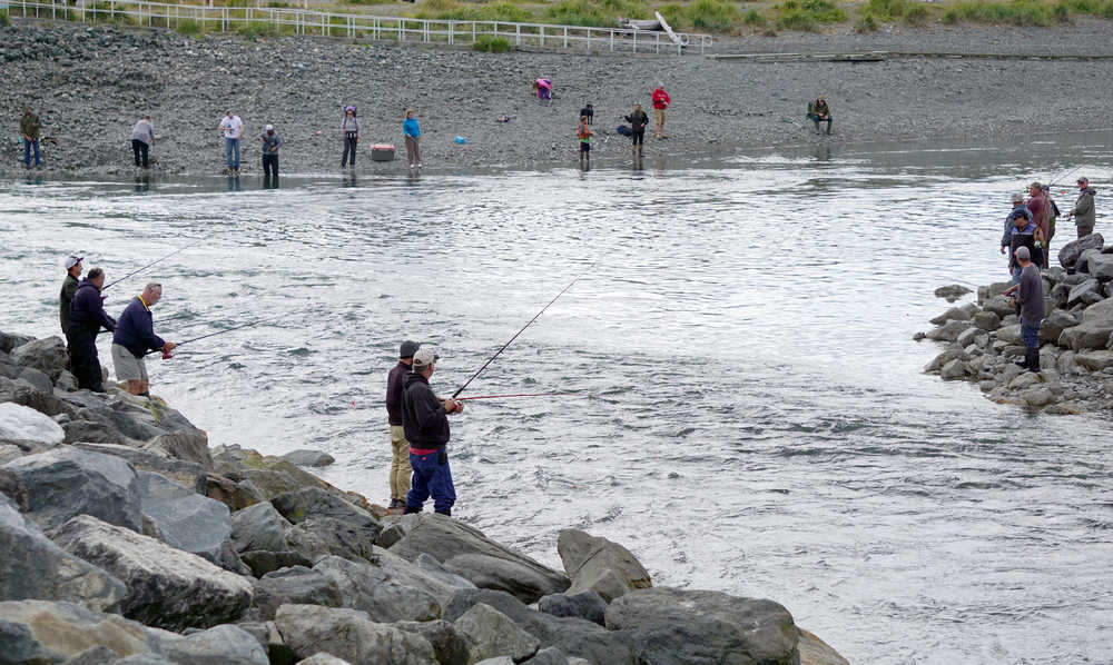 Fishermen fish during the incoming tide on Sunday at the Nick Dudiak Fishing Lagoon on the Homer Spit.