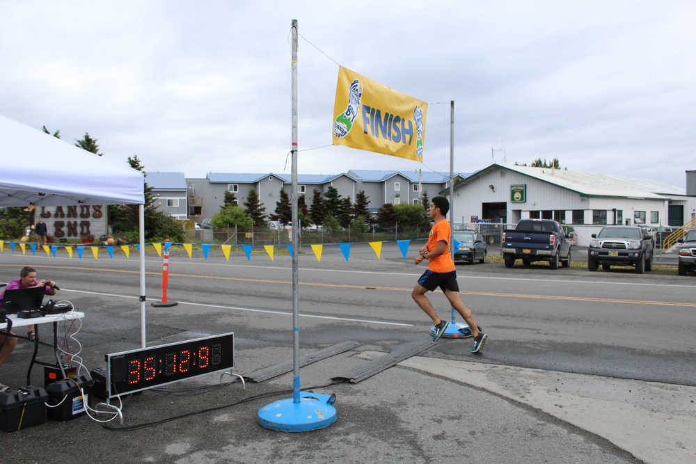 Pedro Ochoa crosses the finish line as the winner of the Spit Run on Saturday, June 25. Ochoa also finished first in the 2014 Spit Run.