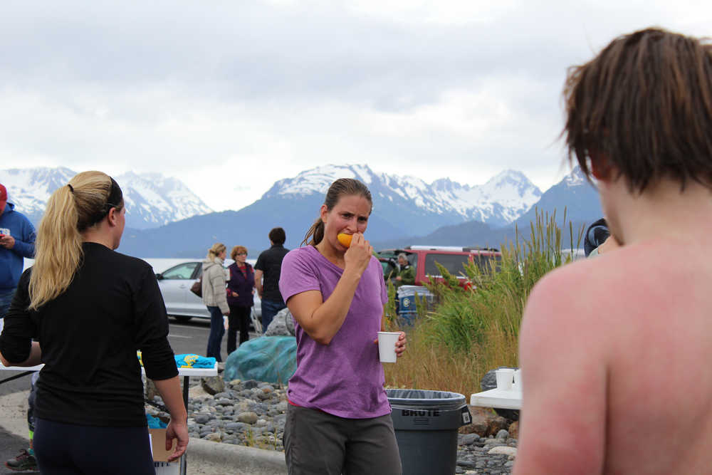 Ashley Van Hemert bites into an orange slice after completing the Spit Run on June 25. Hemert came in 33rd place in the runner's division with a time of 0:46:46.45