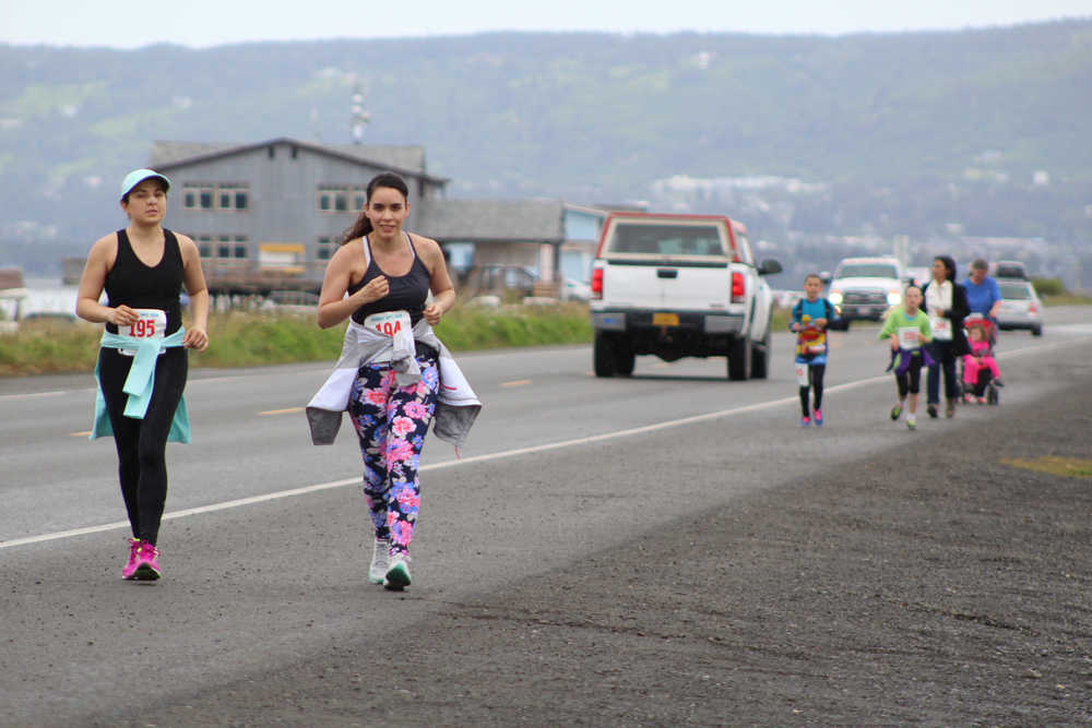 (left to right) Joan Ryan of Anchorage and Fabiola Urbina of Chile run down the Spit as they strive to reach the finish line of the June 25 Spit Run. The two women finished in 205th and 206th place.