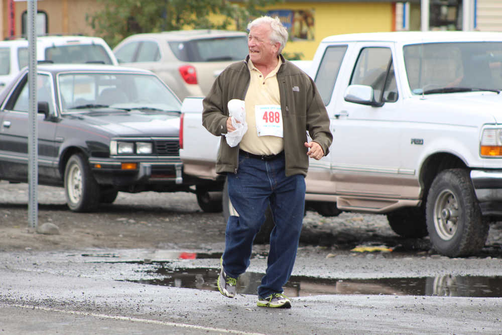 Robert Letson, 68, of Anchor Point laughs as acquintances cheer him on from across the street on the Spit. Letson finished 45th out of 49 in the walkers division of the Saturday, June 25 Spit Run with a time of 1:55:09.64.
