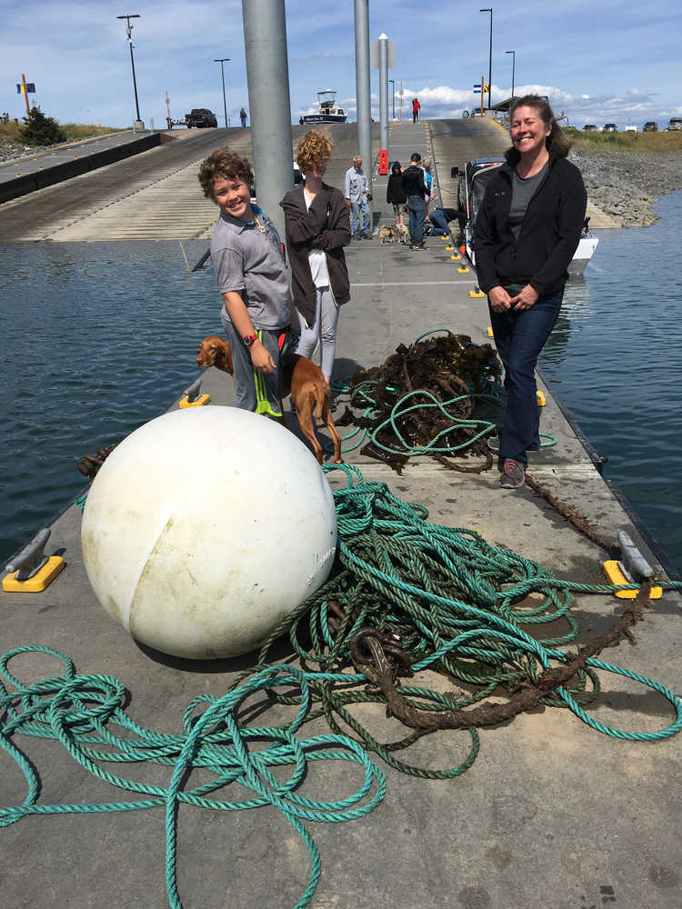 From left to right, Payton Tobin, Rita Burnham and Jill Burnham stand by fishing gear removed from a whale on June 22.-Photo by Deborah Boege-Tobin