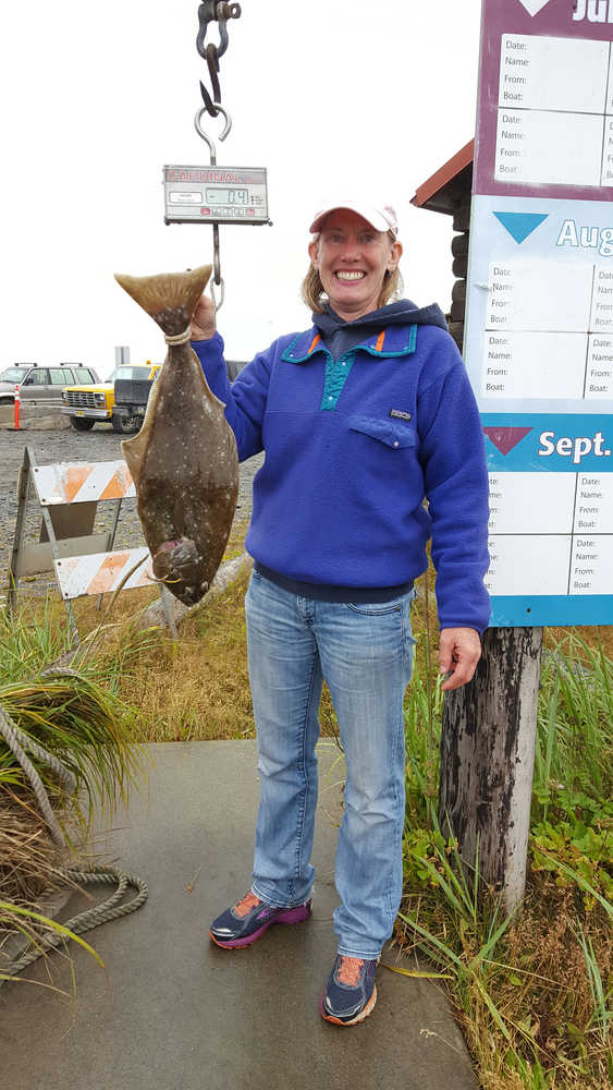 Patricia Perkins of Anchorage poses with the 2014 tagged fish she caught on July 2.