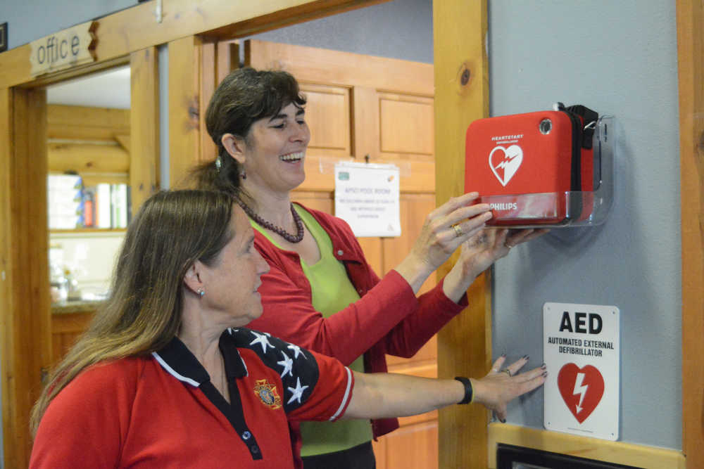 Samantha Cunningham, right, helps Bobby News decide on a location for a public automated external defibrillator at the Anchor Point Senior Center. Cunningham is the Kenai Peninsula Borough Emergency Medical Services coordinator and Ness is president of the senior center board. Cunningham helped get a $43,000 grant from the Tesoro Foundation to install AEDs in public places on the peninsula, including Anchor Point.-Photo by Michael Armstrong, Homer News