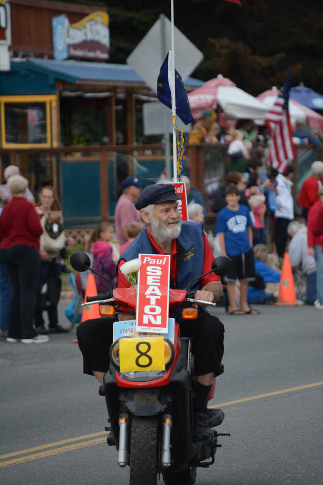 Rep. Paul Seaton, R-Homer, rides a scooter in the Homer Fourth of July Parade.