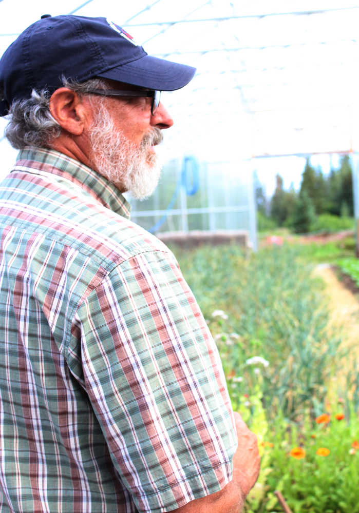 Wayne Jenkins gives a tour of one of the high tunnels at Synergy Gardens during the First Annual Great Garlic Scape Festival. The Jenkins have two high tunnels on their property where they grow a variety of produce.