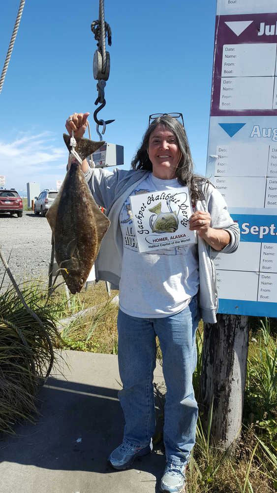 Lita Lubitsh-White of Anchorage poses with the 2016 tagged fish she caught on Sunday, July 17.