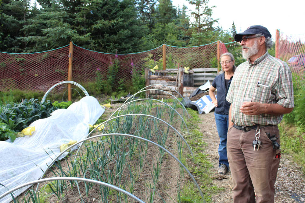 Wayne and Lori Jenkins explain about the crops growing Happiness Garden during their tour of Synergy Gardens on July 10.