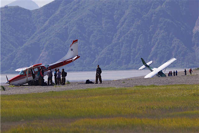 A K-Bay Air plane, left, and a Cook Inlet Aviation plane, right, are bothe nose down on the beach in Chinitina Bay on the west side of Cook Inlet. Both planes hit soft sand while taxiing.