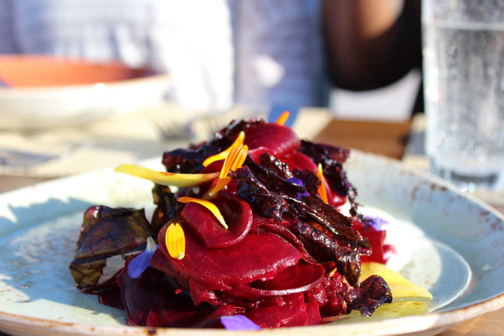 A beet salad with creme fraiche and garnished with flower petals is one of the dishes featuring local produce that the culinary staff at Tutka Bay Lodge create.-Photo by Anna Frost, Homer News