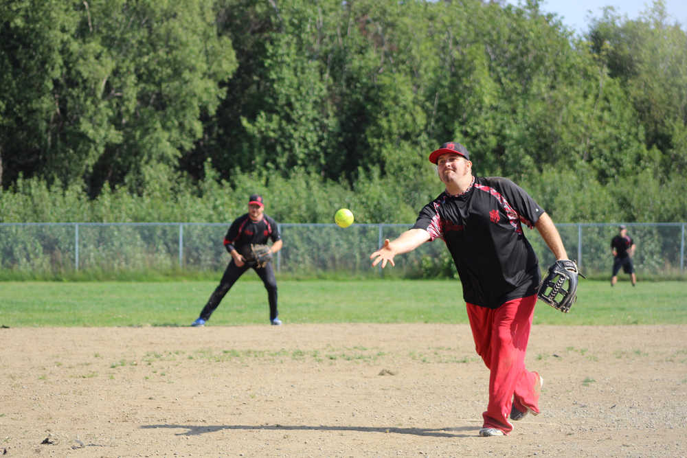 Mean Machine team coach and pitcher Robert Toner lets go off a pitch during the first game against Beluga Lake Lodge in the Homer city league championships.