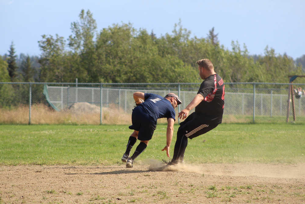 Beluga Lake player Chris Perk turns to make a double play after getting Mean Machine player Joshua Veldstra out at second during the city league championship.