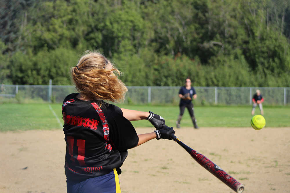 Mean Machine player Hannah Gordon swings at the ball during the second game for the Homer city league tournament championship on Sunday, July 31.