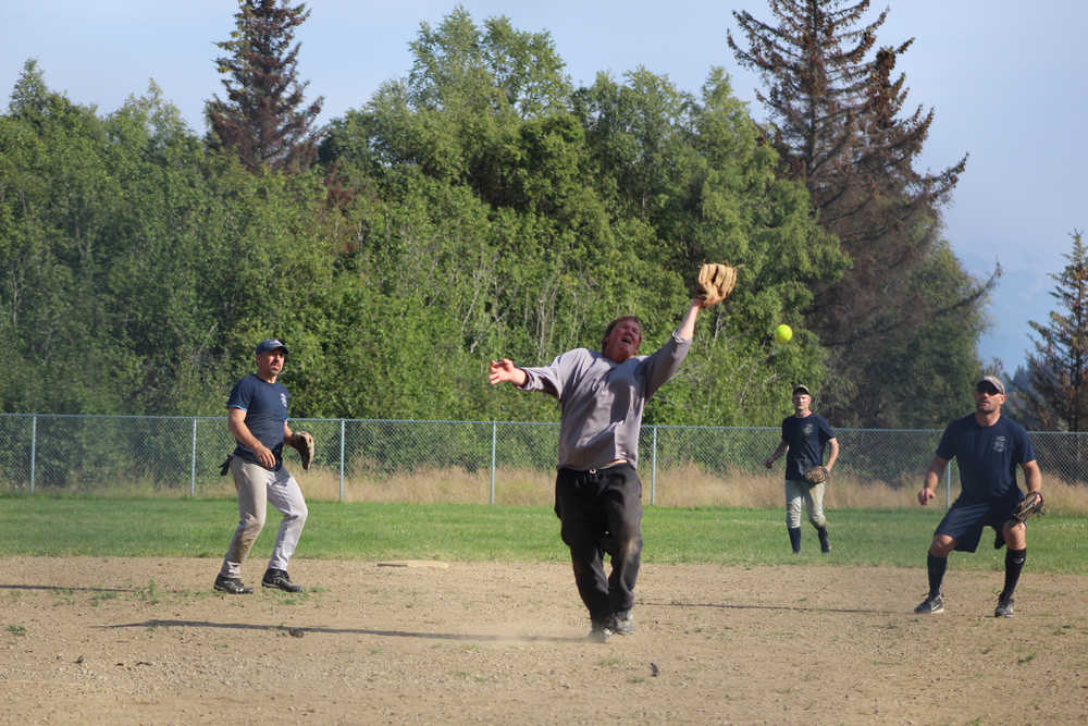 Beluga Lake Lodge pitcher Paul Gavenus misses an infield fly during BLL's second game against Mean Machine for the city tournament championship title on Sunday, July 31.