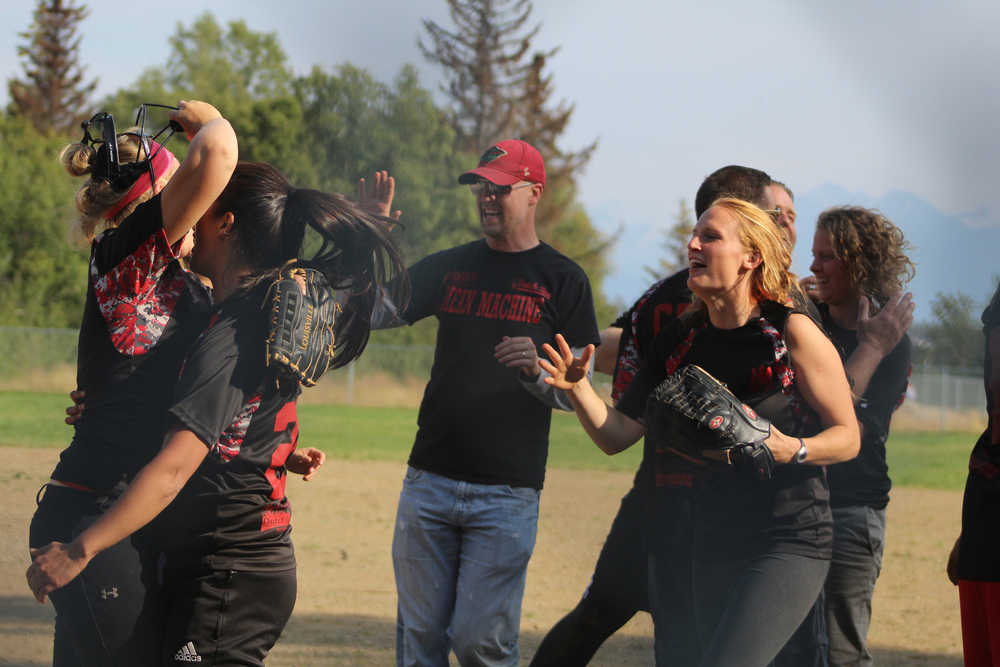 Mean Machine celebrates their victory over Beluga Lake Lodge after two games to win the championship title at the Homer city league softball tournament on Sunday, July 31.
