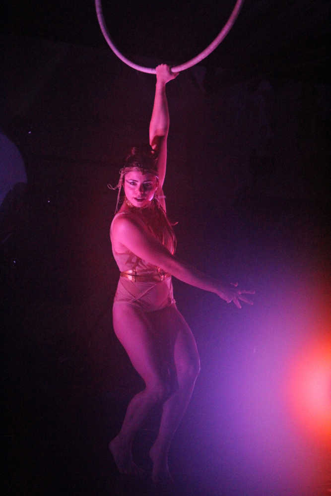 Quixotic aerialist and dancer Megan Stockman hangs from a spinning hoop suspended over the stage at Salmonfest in the early hours of Sunday, August 7. Quixotic uses dance and aerial acts as part of their unique performance style.
