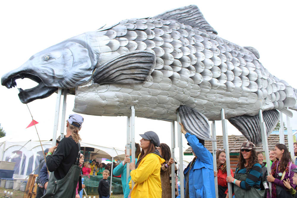 Participants in Salmonfest's King Sam parade carried a giant salmon puppet throughout the festival grounds, followed by a procession of people celebrating the fish.