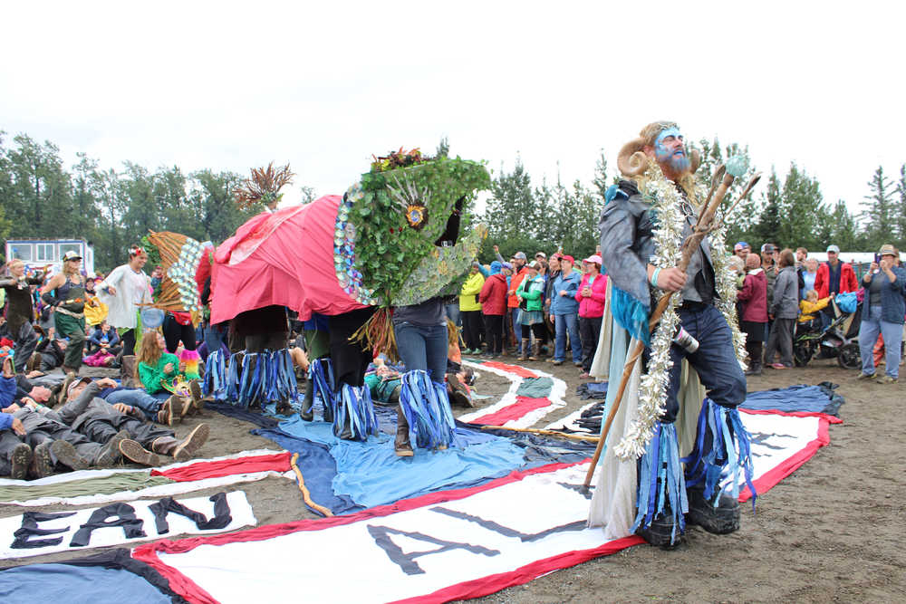 The King Sam parade kicked off at the site of the human mosaic in the rodeo arena where a King Triton and salmon puppet Queen Marine led the procession as a speaker talked about the importance of clean Alaskan waters.