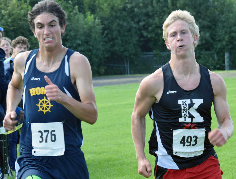 Photo by Jeff Helminiak/Peninsula Clarion Homer's Charlie Menke and Kenai's Karl Danielson sprint to the finish Monday in the junior-senior boys race at the Nikiski Class Races at Nikiski High School. Menke finished seventh, while Danielson was eighth.