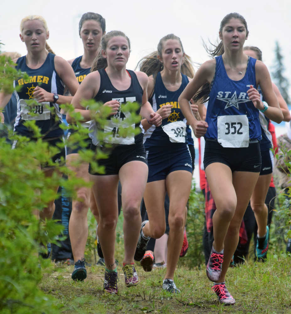 Photo by Jeff Helminiak/Peninsula Clarion Homer's Alex Moseley, Homer's Megan Pitzman, Kenai's Addison Gibson, Homer's Audrey Rosencrans and Homer's Lauren Evarts (obscured) run with the lead pack early in the junior-senior girls race at the Nikiski Class Races at Nikiski High School on Monday.
