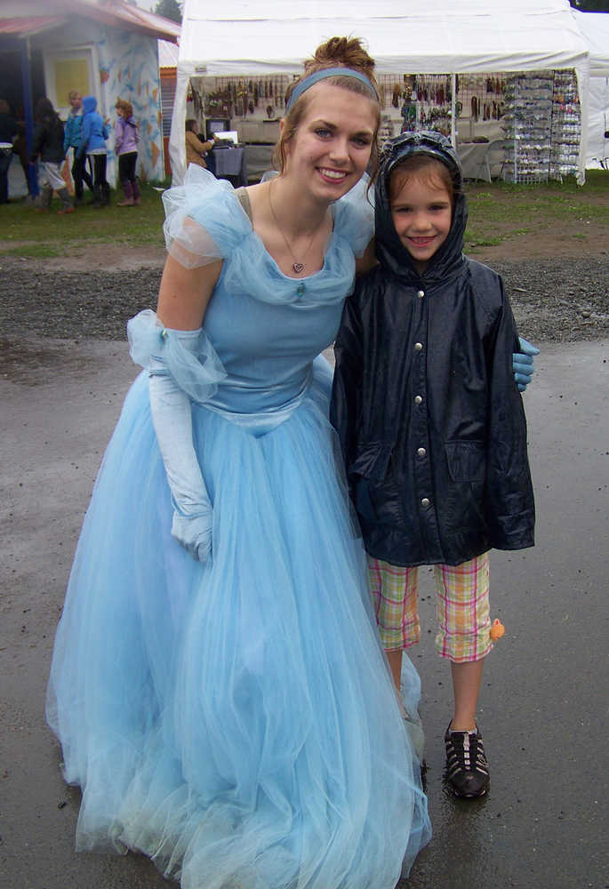 Robin Riley of Ninilchik, dressed as Disney princess Cinderella, poses with with Amy Sobek of Anchorage at the Kenai Peninsula Fair in 2013. This year at the fair princess impersonators will not only roam the fairgrounds, but also have tea with kids and families three times a day in a room decorated like a castle.