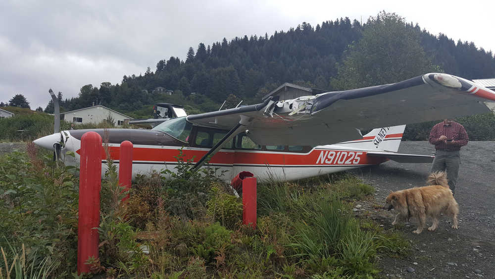 A Smokey Bay Air Cessna 207 lies next to bollards protecting a service hatch near the Nanwalek Airport. The plane crashed on Tuesday morning. No passengers were on board and the pilot escaped injury.