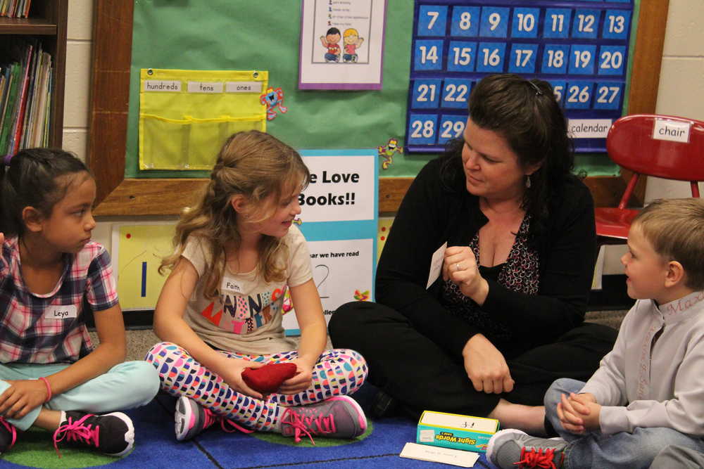 10:53 a.m.: Before lunch, the class plays a reading game. Anne Love shows Faither Overson a sight word flashcard to read aloud to the class. Leya and Maxim Sanarov look on as Faith reads. After she took them to lunch, her day at McNeil Canyon Elementary is over as she is currently a half-time teacher and her class goes to afternoon lessons with another teacher.
