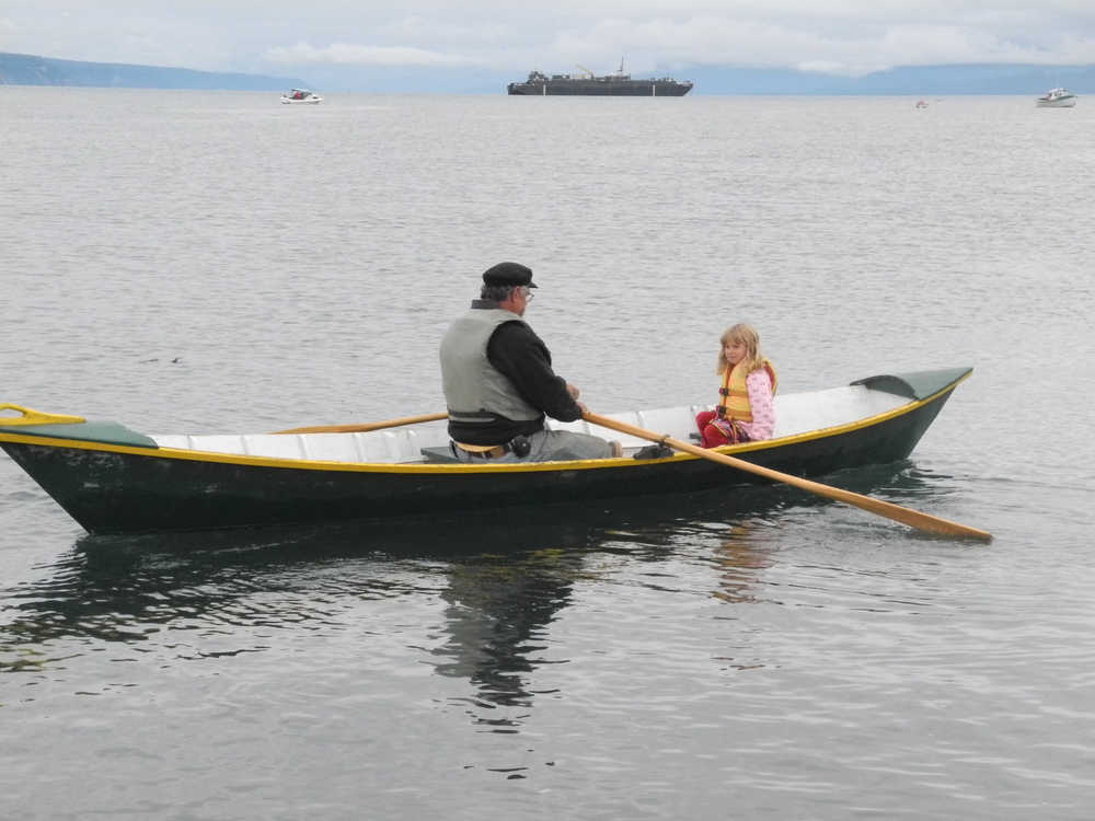 Bumppo Bremicker takes his granddaughter, Zoe Bremicker, for a ride at the Kachemak Bay Wooden Boat Festival last Saturday.