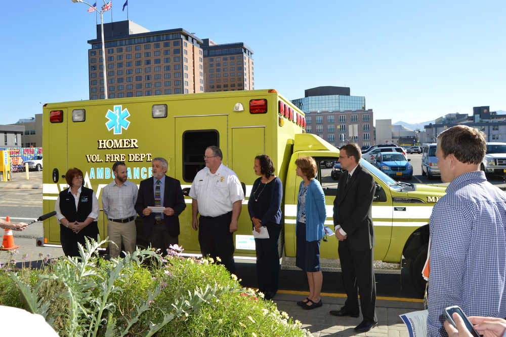 Homer Fire Chief Bob Painter took possession of a new ambulance for the city on Monday in Downtown Anchorage at an announcement bu the USDA Office of Rural Development. From left to right are, Southern Region EMS Council Executive Director Sue Hecks; Department of Health and Social Services Emergency Program Manager Andy Jones, USDA-Rural Development Alaska State Director Jim Nordlund, Painter, USDA-Rural Development Under Secretary Lisa Mensah, Sen. Lisa Murkowski and  Director of Community Facilities Greg Stuckey.