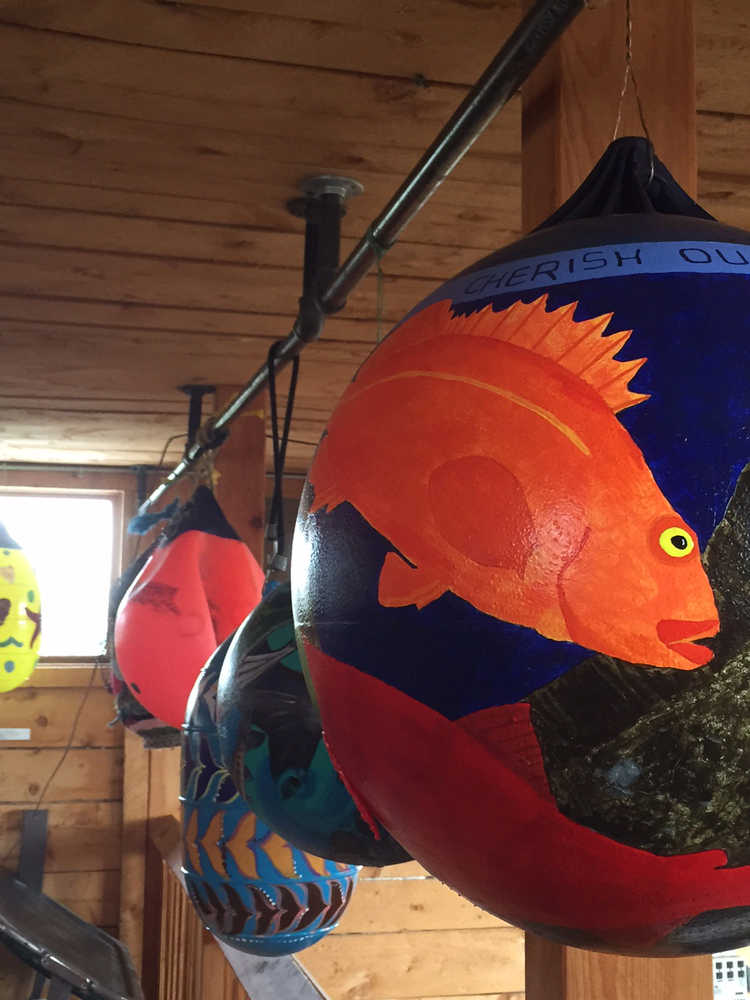 Decorated buoys on display at Alice's Champagne Palace will be auctioned off during the Homer Halibut Festival.